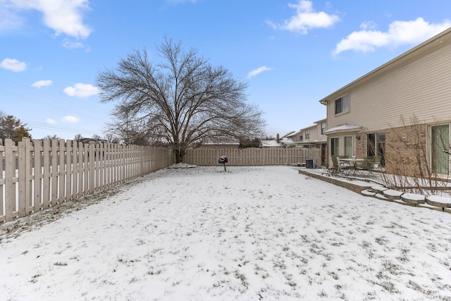 yard layered in snow with central AC