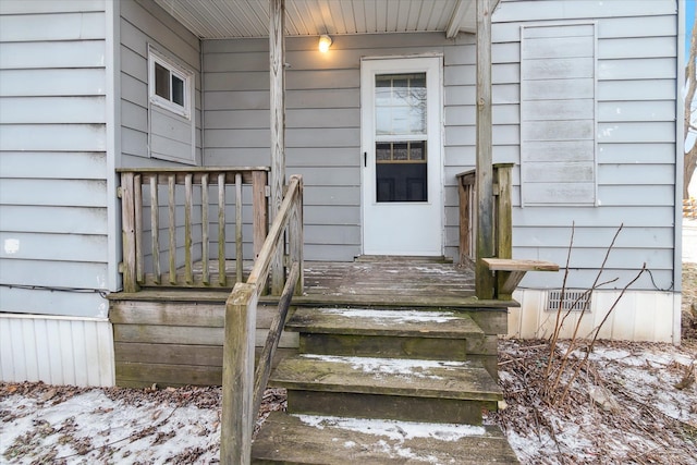 view of snow covered property entrance