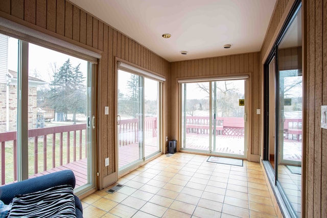 doorway with light tile patterned flooring