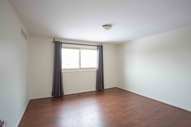 spare room featuring dark hardwood / wood-style flooring