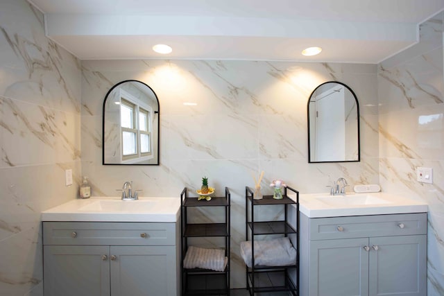 bathroom with vanity and tile walls