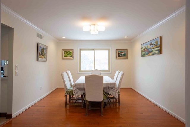 dining area featuring ornamental molding and wood-type flooring