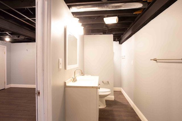 bathroom with vanity, hardwood / wood-style floors, and toilet