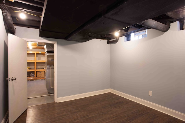 basement with dark hardwood / wood-style flooring