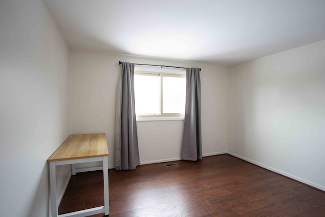 empty room with dark hardwood / wood-style floors