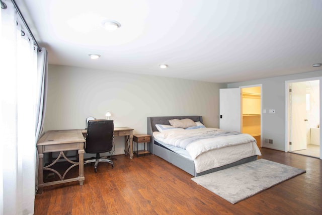 bedroom featuring dark wood-type flooring and a spacious closet