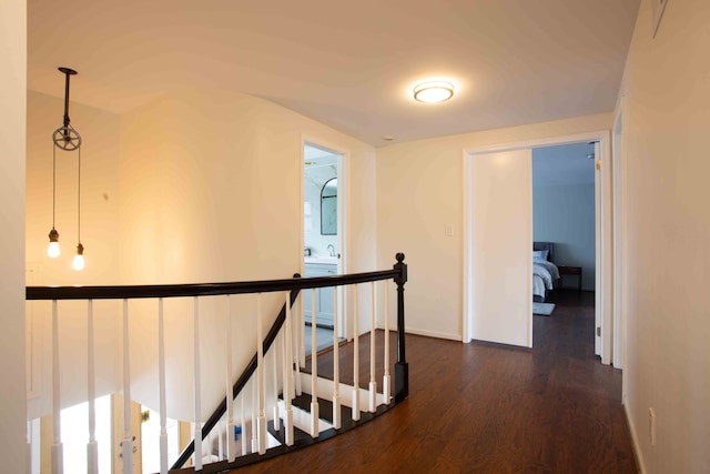 hallway with dark hardwood / wood-style flooring