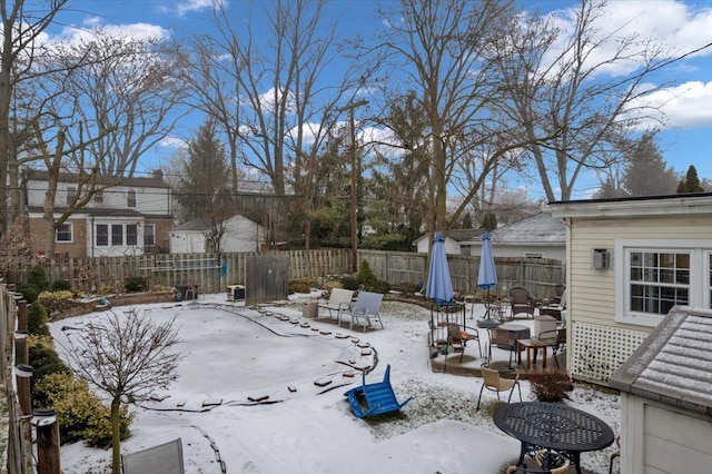 yard layered in snow with a fire pit