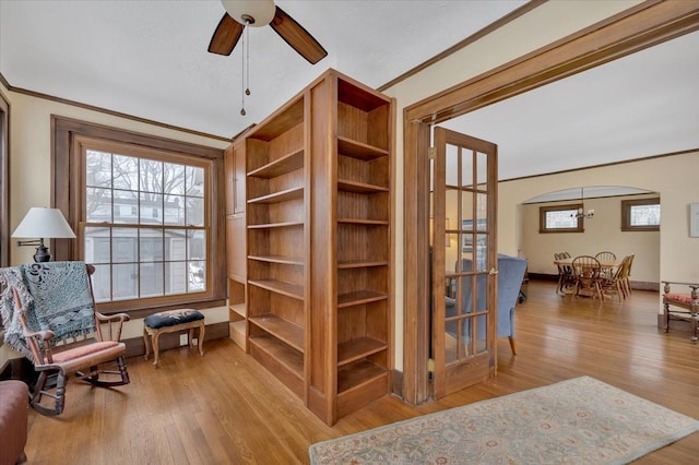 sitting room with crown molding, ceiling fan, a healthy amount of sunlight, and light hardwood / wood-style floors