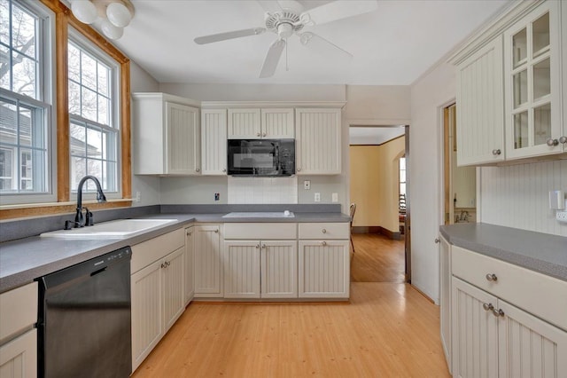 kitchen with white cabinetry, sink, black appliances, and light hardwood / wood-style floors