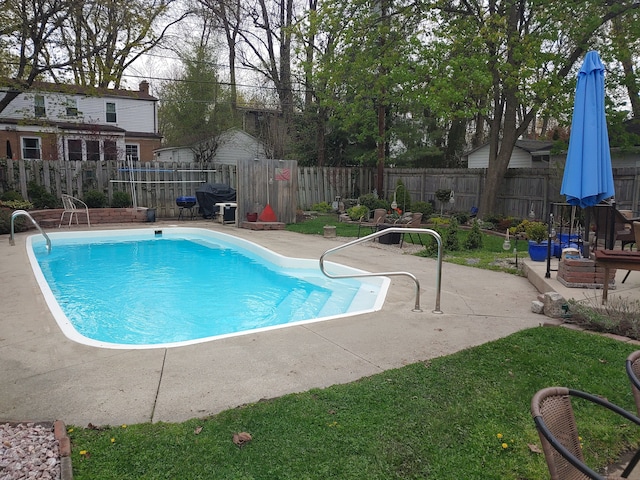 view of swimming pool with grilling area and a patio