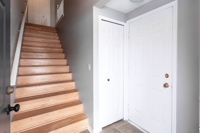 stairs featuring tile patterned floors