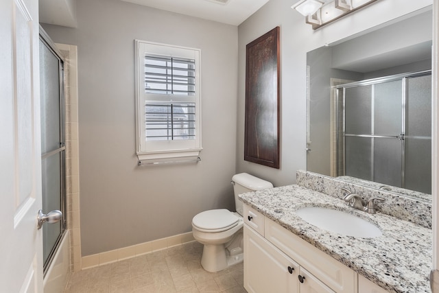 full bathroom featuring vanity, enclosed tub / shower combo, and toilet