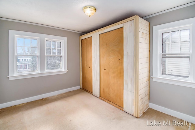 unfurnished bedroom with light carpet and multiple closets