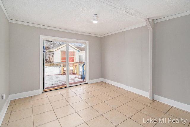 tiled empty room featuring crown molding and a textured ceiling