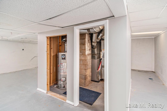 basement with water heater and a paneled ceiling