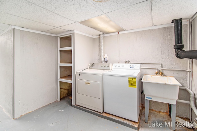 washroom featuring washer and clothes dryer and sink