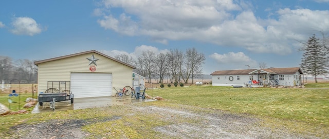 back of property featuring a garage, a yard, and an outdoor structure