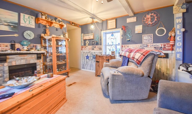 carpeted living room featuring a fireplace and beam ceiling