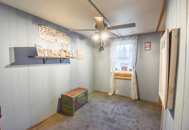 interior space with ceiling fan and carpet flooring