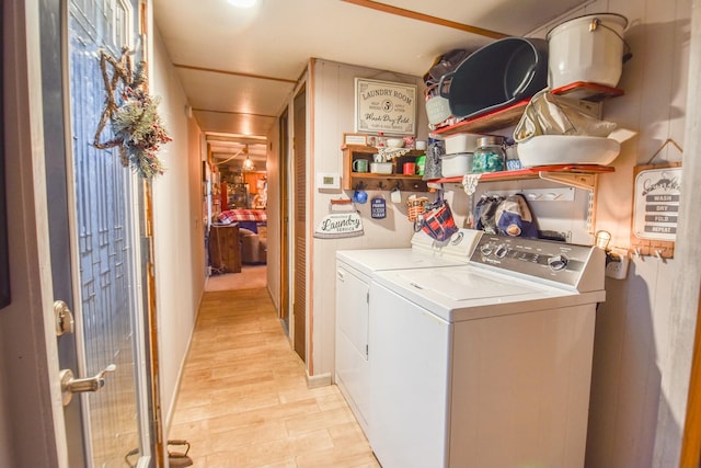 clothes washing area featuring light hardwood / wood-style floors and washing machine and clothes dryer