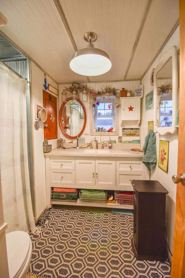 bathroom featuring vanity, wooden ceiling, and toilet