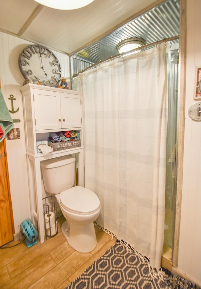 bathroom featuring hardwood / wood-style flooring and toilet