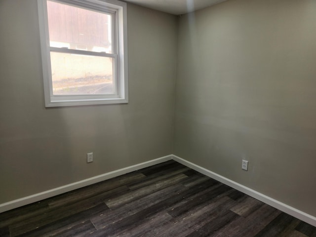 spare room featuring dark hardwood / wood-style floors