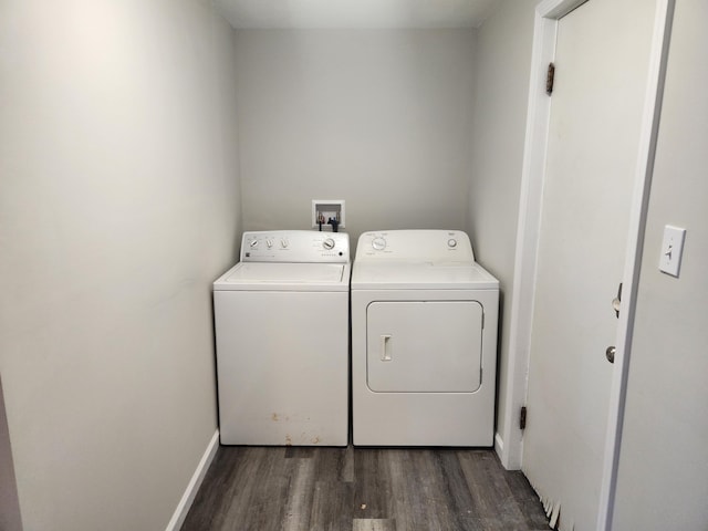 clothes washing area with dark wood-type flooring and independent washer and dryer