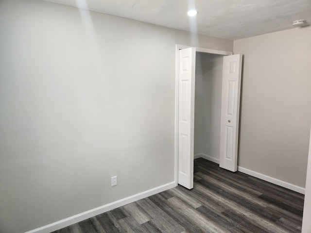 unfurnished bedroom featuring dark hardwood / wood-style floors