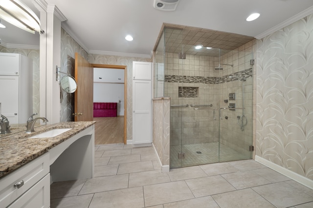 full bath featuring wallpapered walls, ornamental molding, a shower stall, and vanity