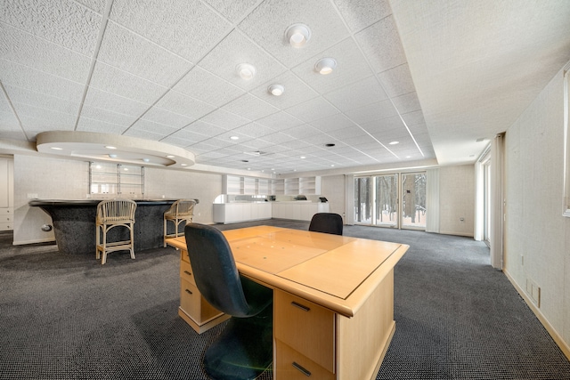 home office featuring recessed lighting, a community bar, and dark colored carpet