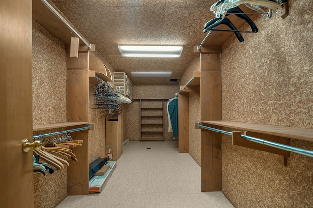 walk in closet with tile patterned floors