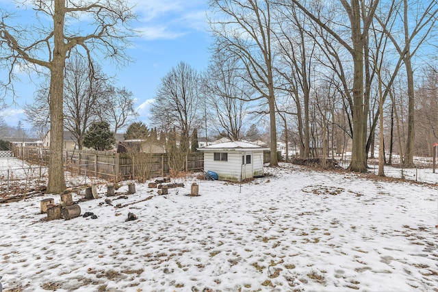 yard covered in snow with a storage unit