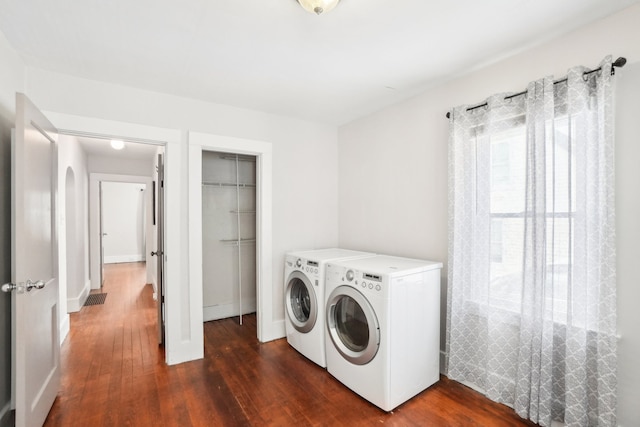 laundry room with washing machine and dryer and dark wood-style flooring