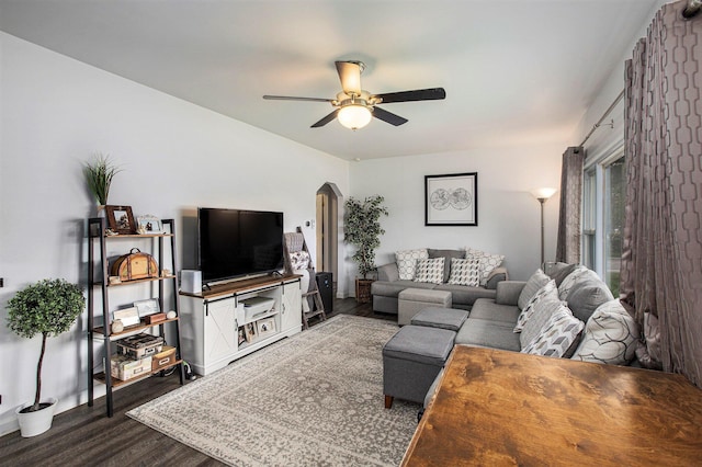 living room with dark wood-type flooring and ceiling fan