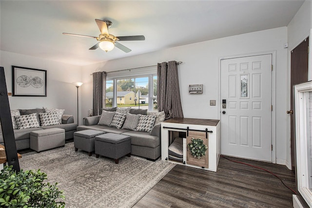 living room with dark wood-type flooring and ceiling fan