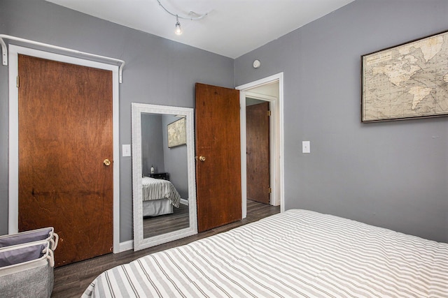 bedroom with dark hardwood / wood-style floors