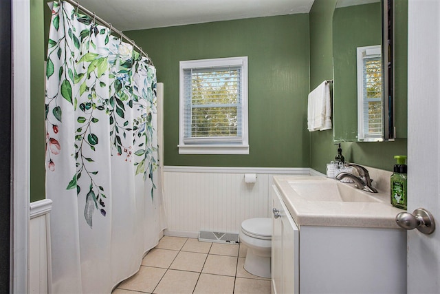 bathroom with tile patterned floors, toilet, curtained shower, and vanity