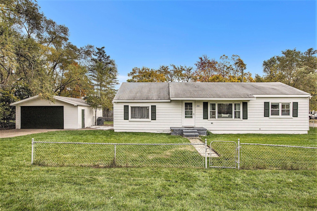 single story home with a garage, an outdoor structure, and a front yard