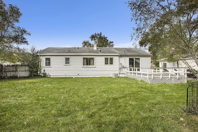 back of house with a yard and a deck