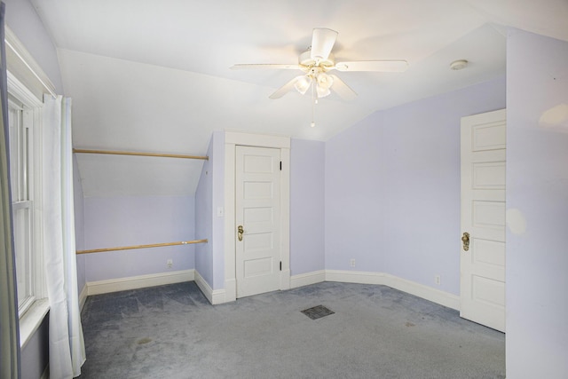 unfurnished bedroom featuring lofted ceiling, carpet floors, and ceiling fan