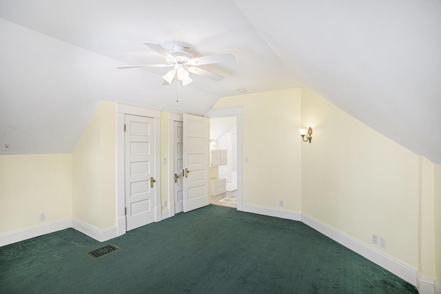 bonus room with lofted ceiling, dark carpet, and ceiling fan