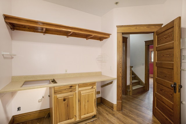 kitchen with sink, hardwood / wood-style flooring, built in desk, and light brown cabinets