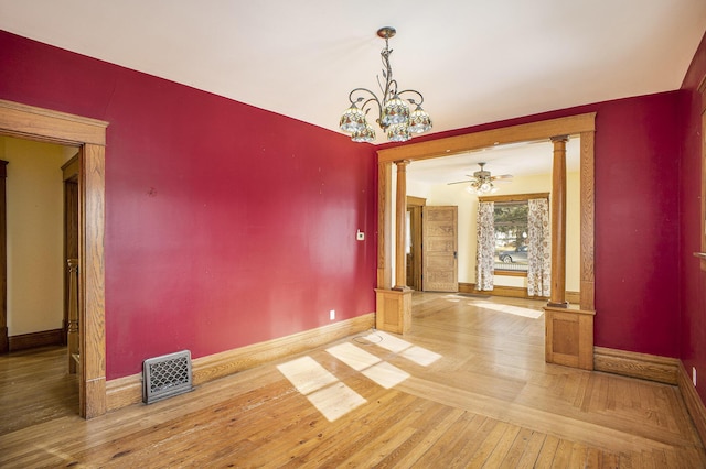 unfurnished dining area featuring decorative columns, wood-type flooring, and ceiling fan