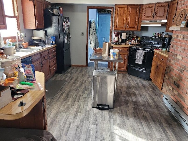 40315 52nd Ave, Paw Paw, MI 49079 - kitchen with black appliances, baseboard heating, a sink, dark wood-style flooring, and under cabinet range hood