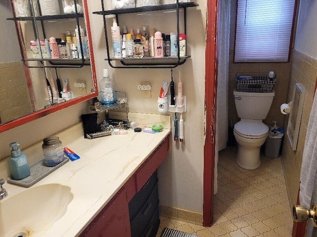 40315 52nd Ave, Paw Paw, MI 49079 - bathroom with toilet, vanity, and tile walls