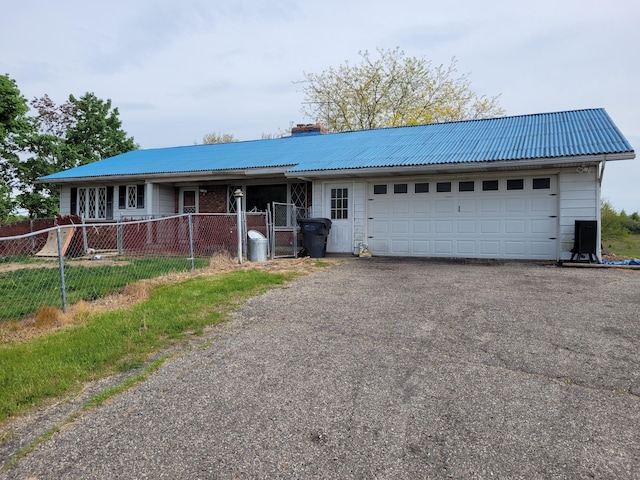 40315 52nd Ave, Paw Paw, MI 49079 - ranch-style house featuring metal roof, a chimney, fence, a garage, and driveway