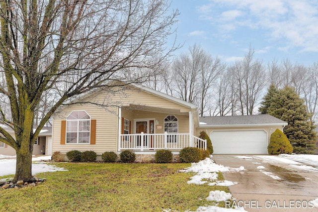 view of front of home with a garage, covered porch, and a front yard