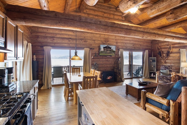 dining room with beamed ceiling, light hardwood / wood-style floors, high vaulted ceiling, and wooden ceiling